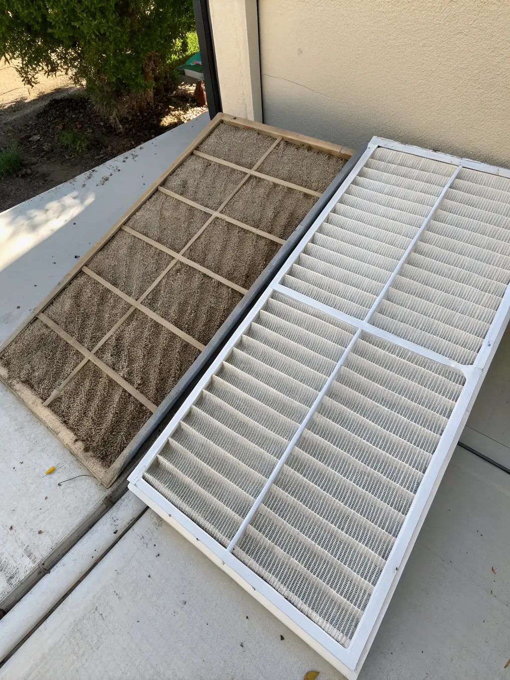 A dirty furnace filter next to a clean one, highlighting the benefits of furnace cleaning for improved air quality and heating efficiency, as part of ALO Duct Cleaning's services.